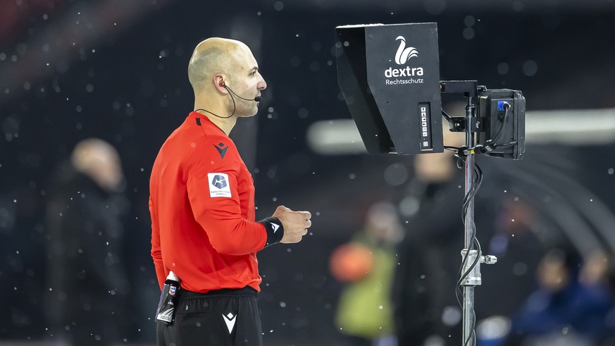 Schiedsrichter Luca Cibelli schaut zum VAR-Bildschirm im Fussball Meisterschaftsspiel der Super League zwischen dem Grasshopper Club Zuerich und dem BSC Young Boys Bern im Letzigrund Stadion, am Samst ...