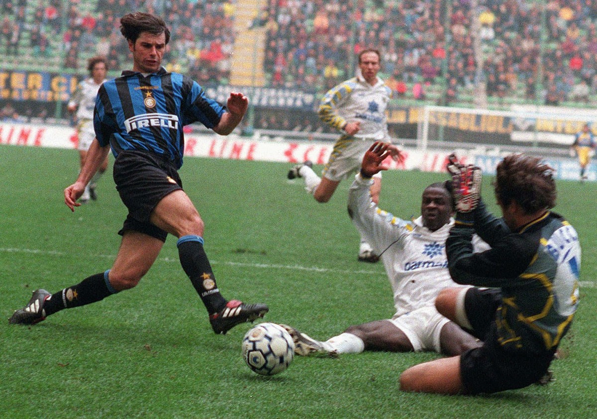 Inter Milan's Swiss forward Ciriaco Sforza kicks the ball as Parma's goalie Luca Bucci tries to stop him, during their Italian first division soccer game, at the Milan San Siro stadium, Sund ...