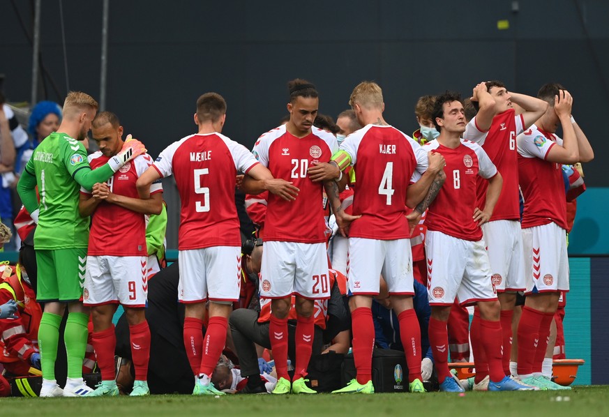 epa09265358 Christian Eriksen (bottom C) of Denmark receives medical assistance during the UEFA EURO 2020 group B preliminary round soccer match between Denmark and Finland in Copenhagen, Denmark, 12  ...