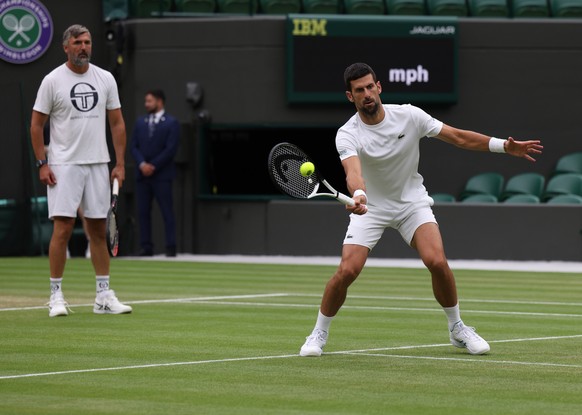 epa10745392 Novak Djokovic (R) of Serbia in action during a training session with his coach Goran Ivanisevic at the Wimbledon Championships, Wimbledon, 14 July 2023. EPA/NEIL HALL EDITORIAL USE ONLY