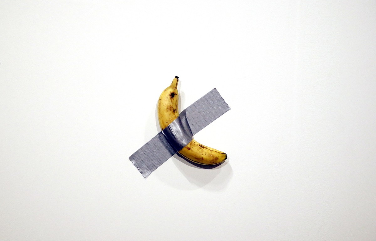 epa08047501 Italian artist Maurizio Cattelan's piece 'Comedian' (a banana duct taped to the wall) is shown during Art Basel in Miami, Florida, USA, 05 December 2019. Art Basel represent ...