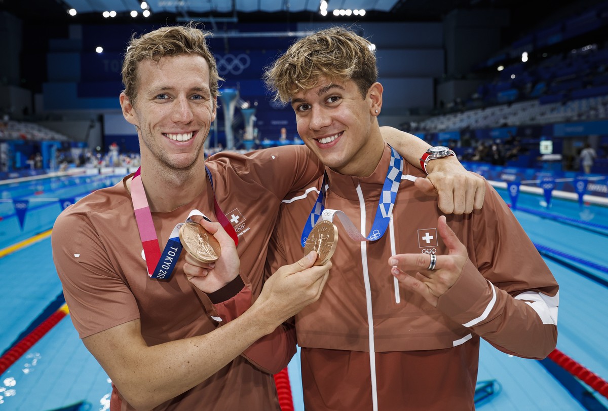 epa09382373 Noe Ponti (R) and Jeremy Desplanches of Switzerland pose with their Bronze medals after finishing third in the men's 100m Butterfly Final (Ponti) and in the men's 200m Individual ...