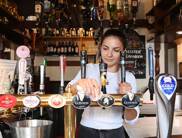 epa08525070 A pub employee cleans a pub ahead of the &#039;Super Saturday&#039; in Soho in London, Britain, 03 July 2020. Pubs will begin to reopen their doors across the UK on 04 July after more than ...