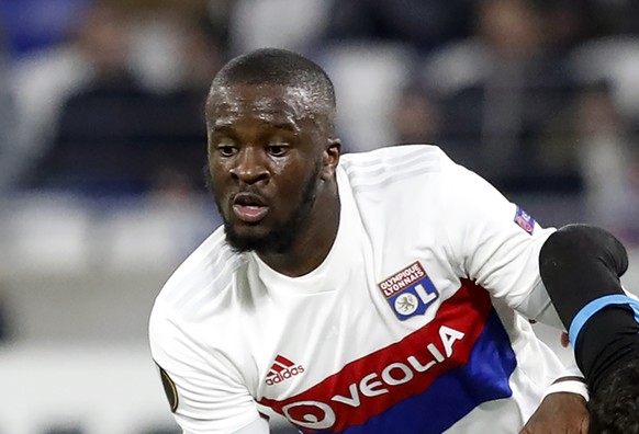 FILE - In this Thursday, Nov. 23, 2017 file photo, Lyon's Tanguy Ndombele challenges for the ball with Apollon's Emilio Zelaya during a Europa League group E soccer match in Decines, near Ly ...