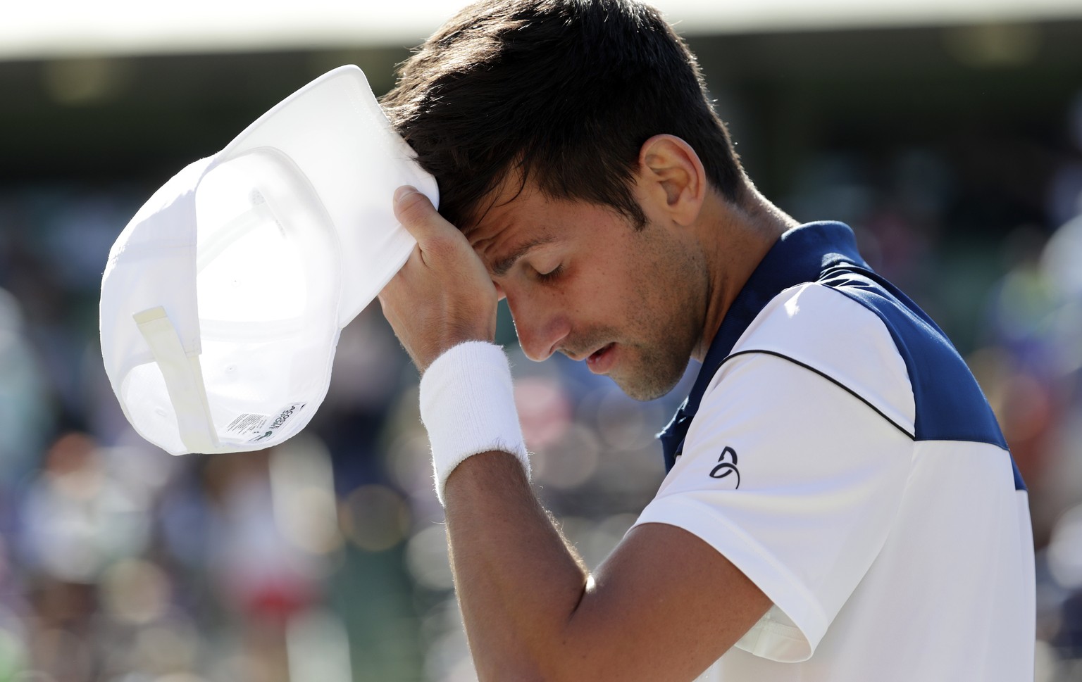 Novak Djokovic, of Serbia, walks to his chair during his match against Benoit Paire, of France, at the Miami Open tennis tournament, Friday, March 23, 2018, in Key Biscayne, Fla. Paire won 6-3, 6-4. ( ...