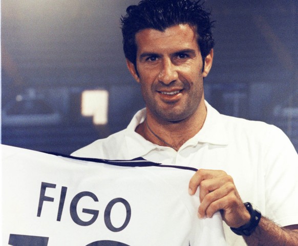 Portuguese soccer player Luis Figo holds up the Real Madrid shirt he will be wearing next season after being presented to the press at the Bernabeu stadium in Madrid, Spain Monday, July 24, 2000. Figo ...