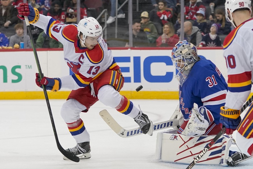 New York Rangers goaltender Igor Shesterkin (31) makes the save against New Jersey Devils center Nico Hischier (13) during the first period of an NHL hockey game, Saturday, Jan. 7, 2023, in Newark, N. ...