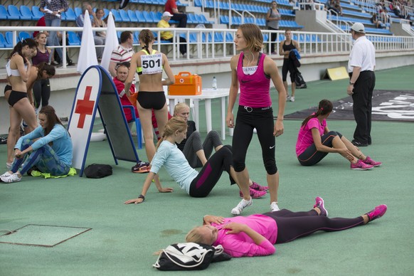 FILE - In this Thursday, July 21, 2016 file photo, Russia's athletes rest before competing at the Russian Athletics Cup, at Zhukovsky, outside Moscow, Russia. A year on from a damning report whic ...