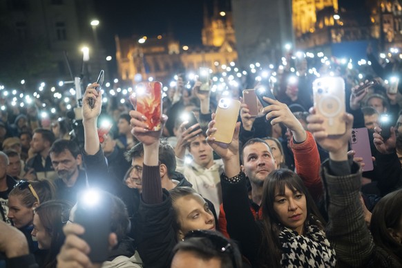 People listen to the speech of former Hungarian government insider Peter Magyar next to Kossuth Square on Tuesdy, in Budapest, Hungary, March 26, 2024. Magyar on Tuesday released a recording that he c ...