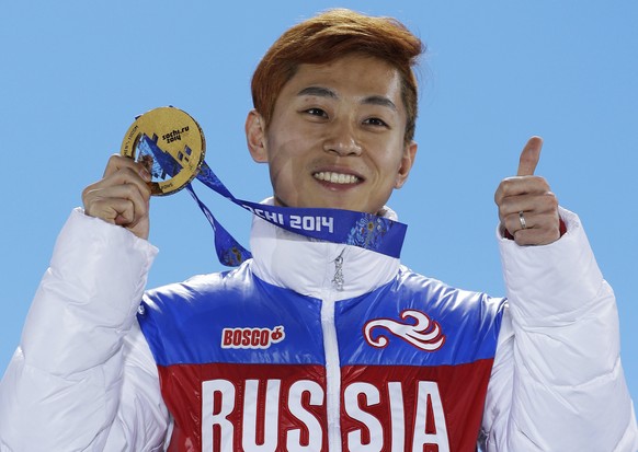 FILE - In this Feb. 15, 2014, file photo, men&#039;s 1,000-meter short track speedskating gold medalist Viktor Ahn, of Russia, gestures while holding his medal during the medals ceremony at the Winter ...
