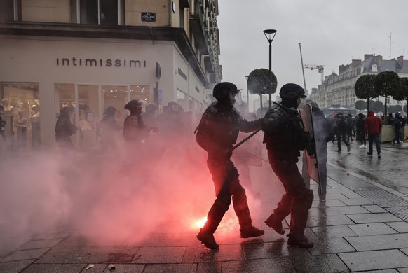 Riot police scuffle with protesters during a protest in Rennes, western France, Wednesday, March 22, 2023. Macron said Wednesday that the pension bill that he pushed through without a vote in parliame ...