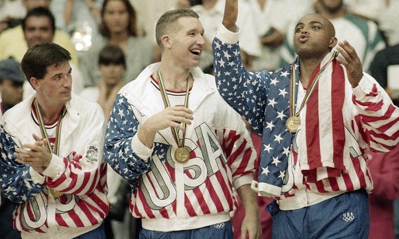 FILE - In this Aug. 8, 1992, file photo, From left the USA&#039;s John Stockton, Chris Mullin, and Charles Barkley rejoice with their gold medals after beating Croatia 117-85 in the gold medal game in ...