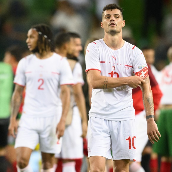 Switzerland&#039;s Granit Xhaka, right, and Mario Gavranovic, left, look disappointed after losing the UEFA Nations League group A2 soccer match between Portugal and Switzerland at the Estadio Jose Al ...