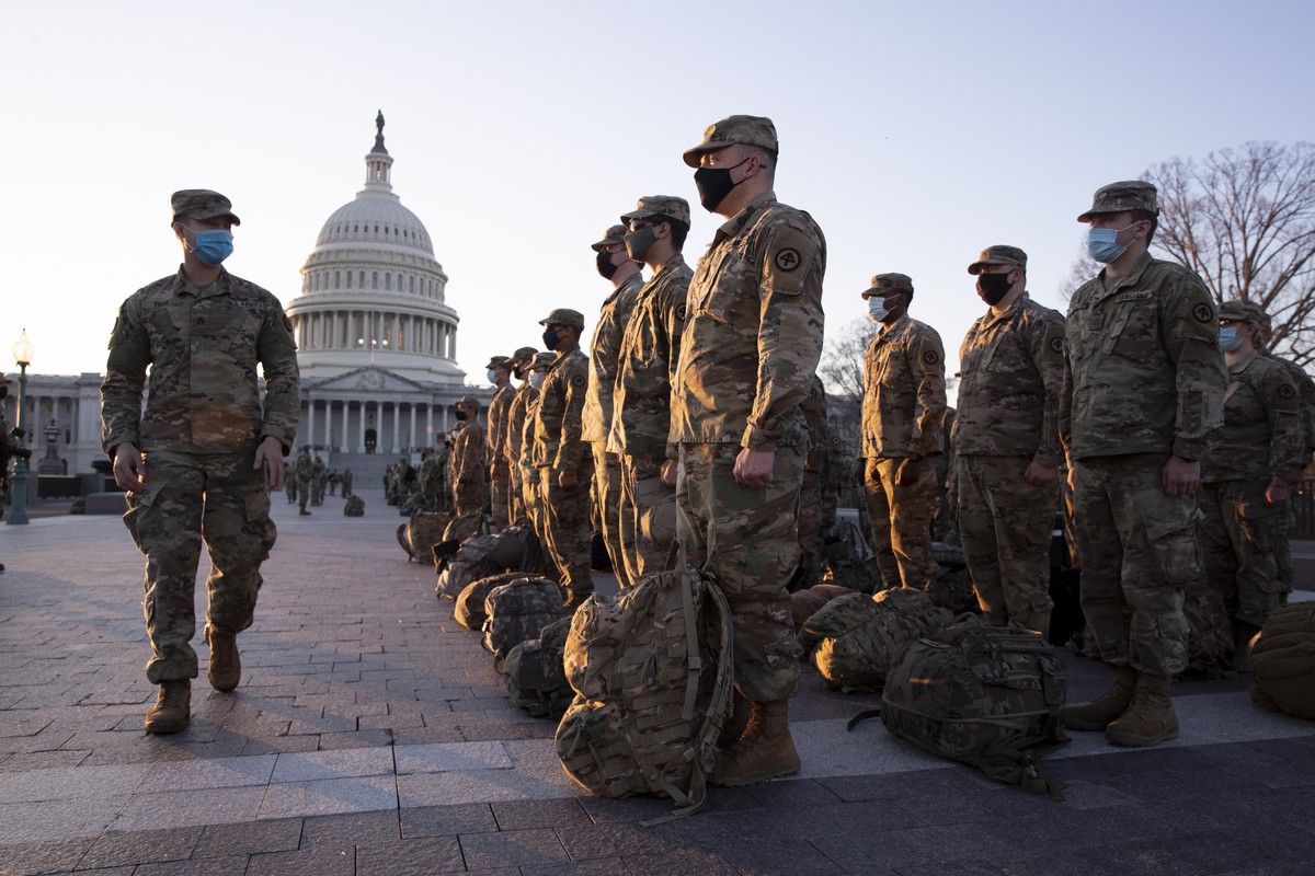 epa08933928 Members of the US National Guard gather on the grounds of the East Front of the US Capitol in Washington, DC, USA, 12 January 2021. At least ten thousand troops of the National Guard will ...