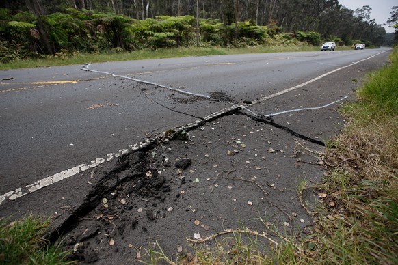 epa06743254 A crack is seen on Highway 11 after a 3.5 magnitude earthquake hit the area near the entrance to Hawaii Volcanoes National Park, Hawaii, USA, 16 May 2018. A 3.5 magnitude earthquake on 16  ...
