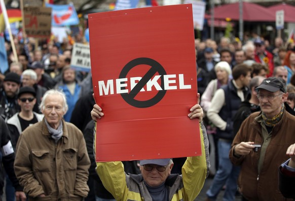 People take part in a protest rally of the German party &#039;Alternative fuer Deutschland, AfD&#039; (Alternative for Germany) in Berlin, Germany, Saturday, Nov. 7, 2015. The anti-immigration party h ...