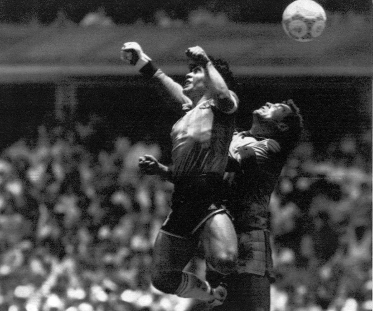 Argentina's Diego Maradona (10), left, seen in the controversial action in which he knocked the ball with his left hand into the net of England Goalie Peter Shilton, right, to score 1:0. Argentin ...