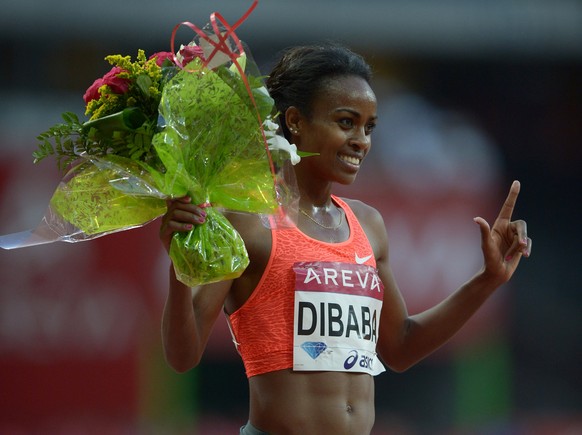 Jul 4, 2015; Saint-Denis, France; Genzebe Dibaba (ETH) celebrates after winning the womens 5,000m in 14:15.41 during the 2015 Meeting Areva at Stade de France. Mandatory Credit: Kirby Lee-USA TODAY Sp ...