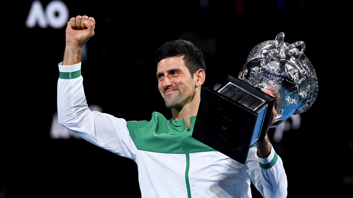 epa09668648 (FILE) Novak Djokovic of Serbia lifts the Norman Brooks Challenge Cup after winning his Men's singles finals match against Daniil Medvedev of Russia on Day 14 of the Australian Open G ...