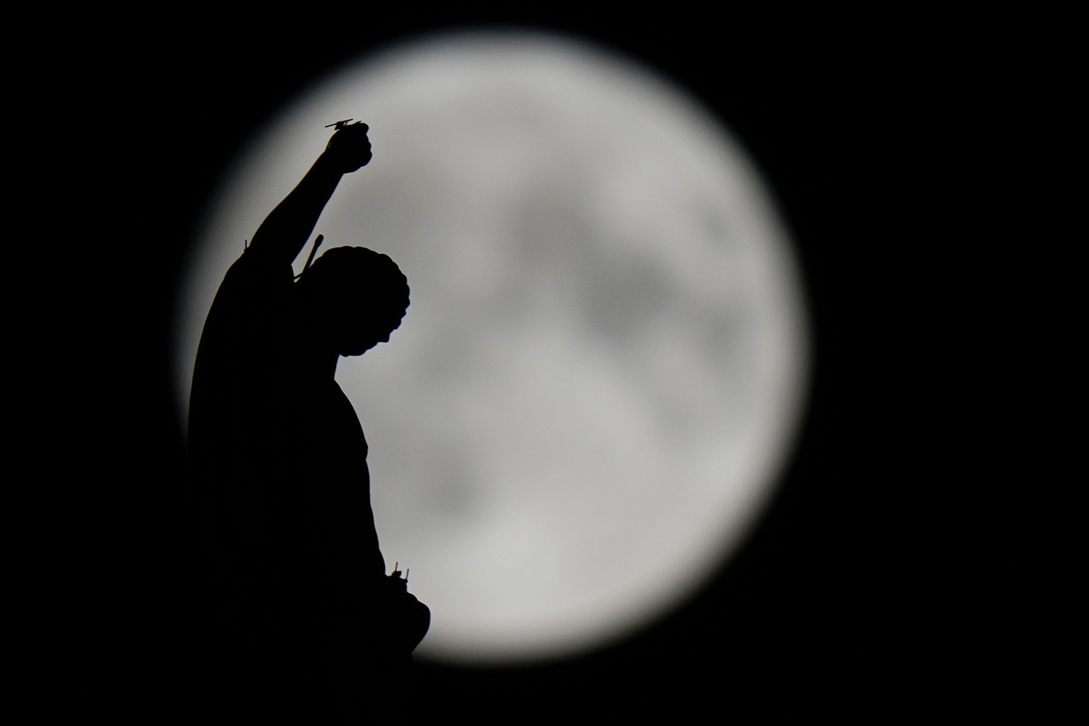The August Super Blue Moon sets behind a spire of the Duomo gothic cathedral in Milan, Italy, Wednesday, Aug. 30, 2023. The cosmic curtain rises Wednesday night with the second full moon of the month, ...