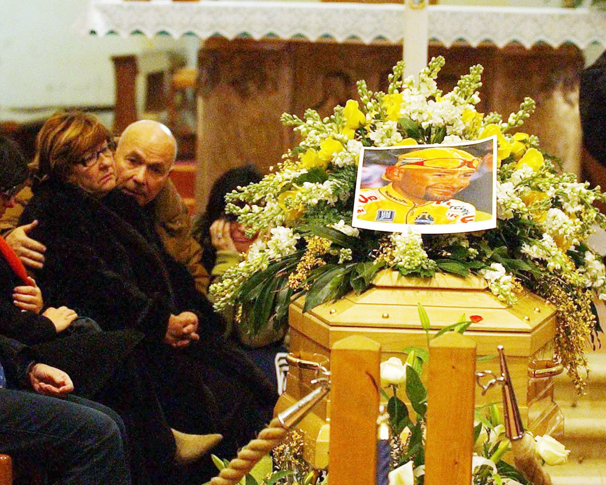 Relatives mourn next to the coffin of Italian cyclist and former Tour de France and Giro d'Italia race winner Marco Pantani, inside the San Giacomo church in Cesenatico, northern Italy, Tuesday,  ...