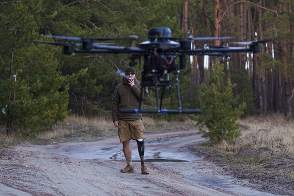 Maksym Vysotskyi, 42, a Ukrainian Drone Unit Commander of the 82nd assault brigade smokes a cigar during a drone test flight in Kharkiv region, Ukraine, Feb. 2, 2025. (AP Photo/Evgeniy Maloletka)
