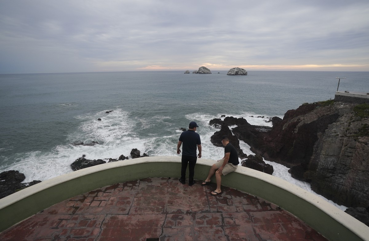 People relax at the shore in Mazatlan, Mexico, Sunday, Oct. 2, 2022. Hurricane Orlene, at Category 3 strength, is heading for a collision with Mexico's northwest Pacific coast between the tourist ...
