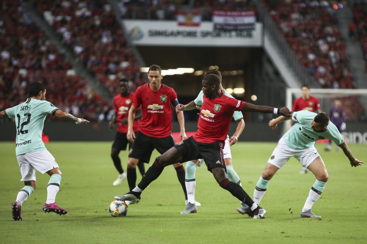 Manchester United's Paul Pogba, centre, in action during the match during the International Champions Cup soccer match between Manchester United and Milan in Singapore, Saturday, July 20, 2019. ( ...