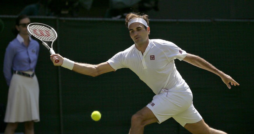 Roger Federer of Switzerland returns to Serbia&#039;s Dusan Lajovic during their Men&#039;s Singles first round match at the Wimbledon Tennis Championships in London, Monday July 2, 2018. (AP Photo/Ti ...