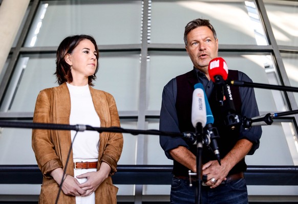 epa09508500 Green party (Die Gruenen) co-chairman Robert Habeck (R) and Green party (Die Gruenen) co-chairwoman Annalena Baerbock give a press conference in Berlin, Germany, 06 October 2021. The party ...