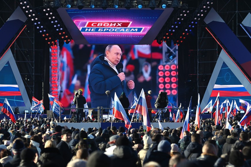 Russian President Vladimir Putin seen on the big screen as he delivers his speech at the concert marking the eighth anniversary of the referendum on the state status of Crimea and Sevastopol and its r ...