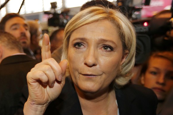 Marine Le Pen (R), French National Front (FN) political party leader and candidate for French 2017 presidential election, and her bodyguard Thierry Legier, visit the International Agricultural Show in ...