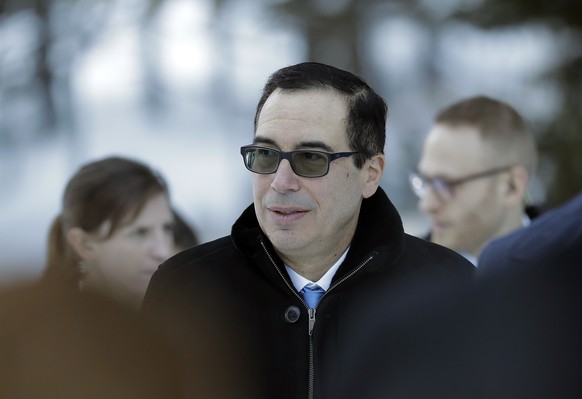 Steven Mnuchin, United States Secretary of the Treasury, walks through the snow during the annual meeting of the World Economic Forum in Davos, Switzerland, Wednesday, Jan. 24, 2018. (AP Photo/Markus  ...