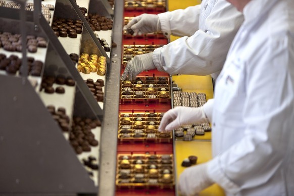 Employees of chocolate factory "Lindt &amp; Spruengli AG" in Kilchberg in the canton of Zurich, Switzerland, put together "Pralines du Confiseur" assortments, pictured on March 10, ...