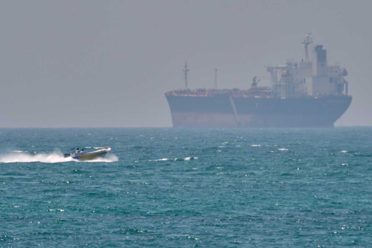 A boat sails past a tanker anchored on the Strait of Hormuz off the coast Qeshm island, Iran, Saturday, April 18, 2026. (AP Photo/Asghar Besharati)
Iran War