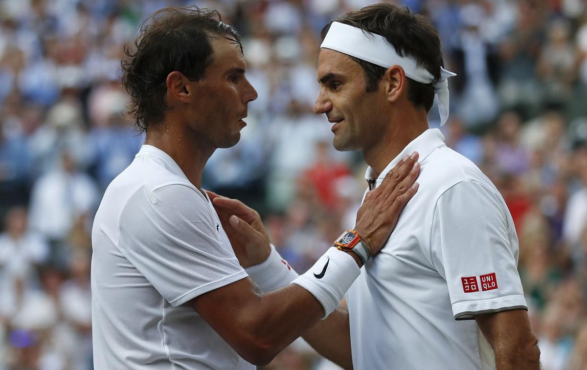 Switzerland's Roger Federer, right, greets Spain's Rafael Nadal after beating him in a Men's singles semifinal match on day eleven of the Wimbledon Tennis Championships in London, Frida ...