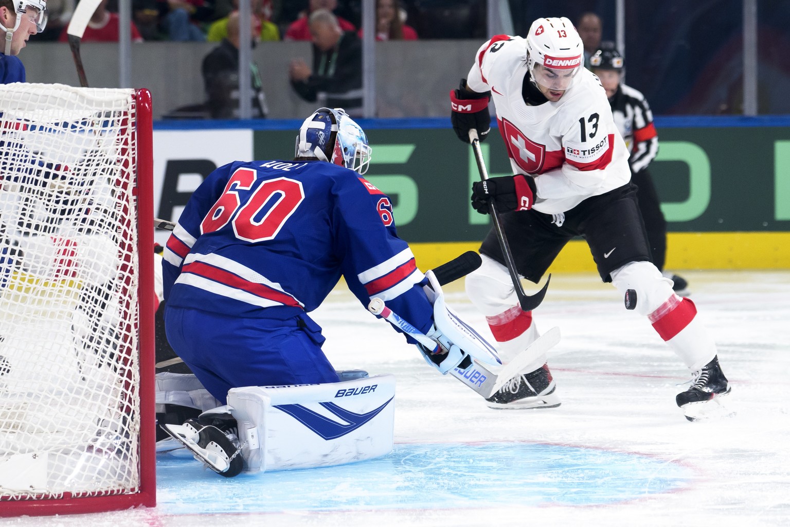 epa12961204 USA's goaltender Joseph Woll (L) in action against Switzerland's Nico Hischier during the 2026 IIHF Men's Ice Hockey World Championship preliminary round group A game betwee ...