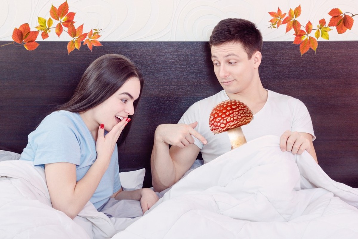 Handsome satisfied man sure in himself showing under cover in bedroom strong penis erection to pretty surprised woman. Sexy young couple in morning, domestic atmosphere. Photo of healthy male potency.