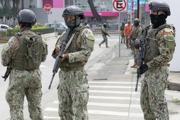 epa11072732 Members of Ecuador Armed Forces stand guard outside TC Television channel during a visit of President Daniel Noboa, in Guayaquil, Ecuador, 12 January 2024. Ecuador is in turmoil after TC T ...