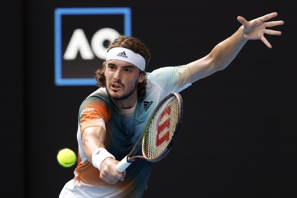 Stefanos Tsitsipas of Greece plays a backhand return to Jannik Sinner of Italy during their quarterfinal match at the Australian Open tennis championships in Melbourne, Australia, Wednesday, Jan. 26,  ...