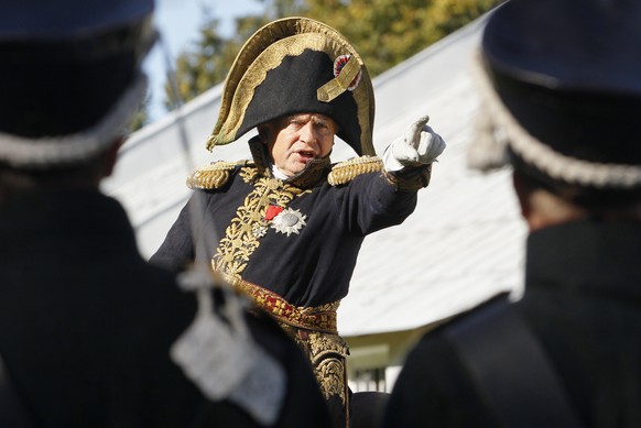 FILE - In this Sunday, Sept. 16, 2012 file photo, Oleg Sokolov, a history professor at St. Petersburg State University, wears a 1812-era French army general&#039;s uniforms during a staged battle re-e ...