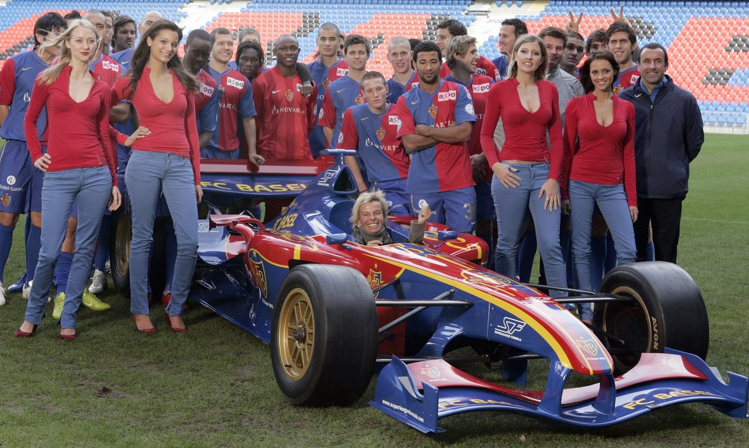 The team of Switzerland&#039;s soccer club FC Basel with the president Gigi Oeri, in the car, presents the Superleague Formula racing car in the colors of the club on Friday, December 7, 2008 in Basel ...
