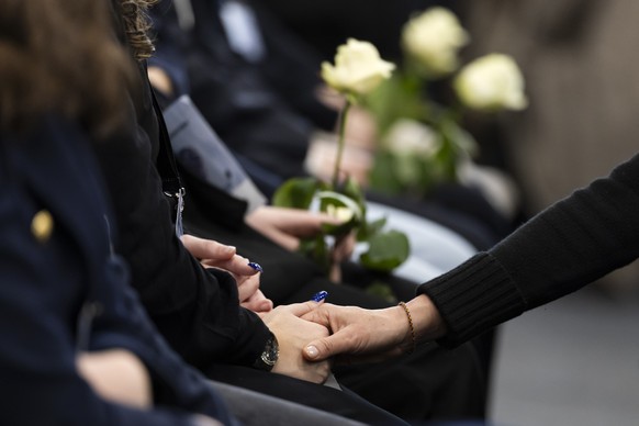epa12638398 Participants hold each other by the hands during the official commemorative ceremony and the national day of mourning following the deadly fire at the 'Le Constellation' bar in C ...