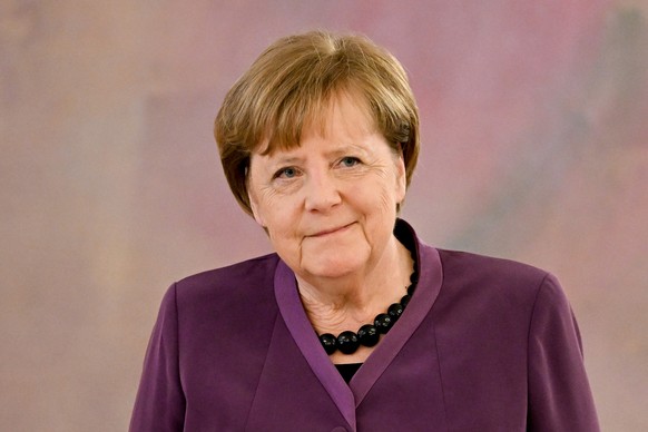 epa10577255 Former German Chancellor Angela Merkel (R) looks on as she is introduced by German President Frank-Walter Steinmeier (unseen) as laureate to receive the &#039;Grand Cross of the Order of M ...