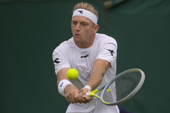 Spain's Alejandro Davidovich Fokina returns the ball to Poland's Hubert Hurkacz during their men's singles tennis match on day one of the Wimbledon tennis championships in London, Monday, June 27, 2022. (AP Photo/Alastair Grant)
