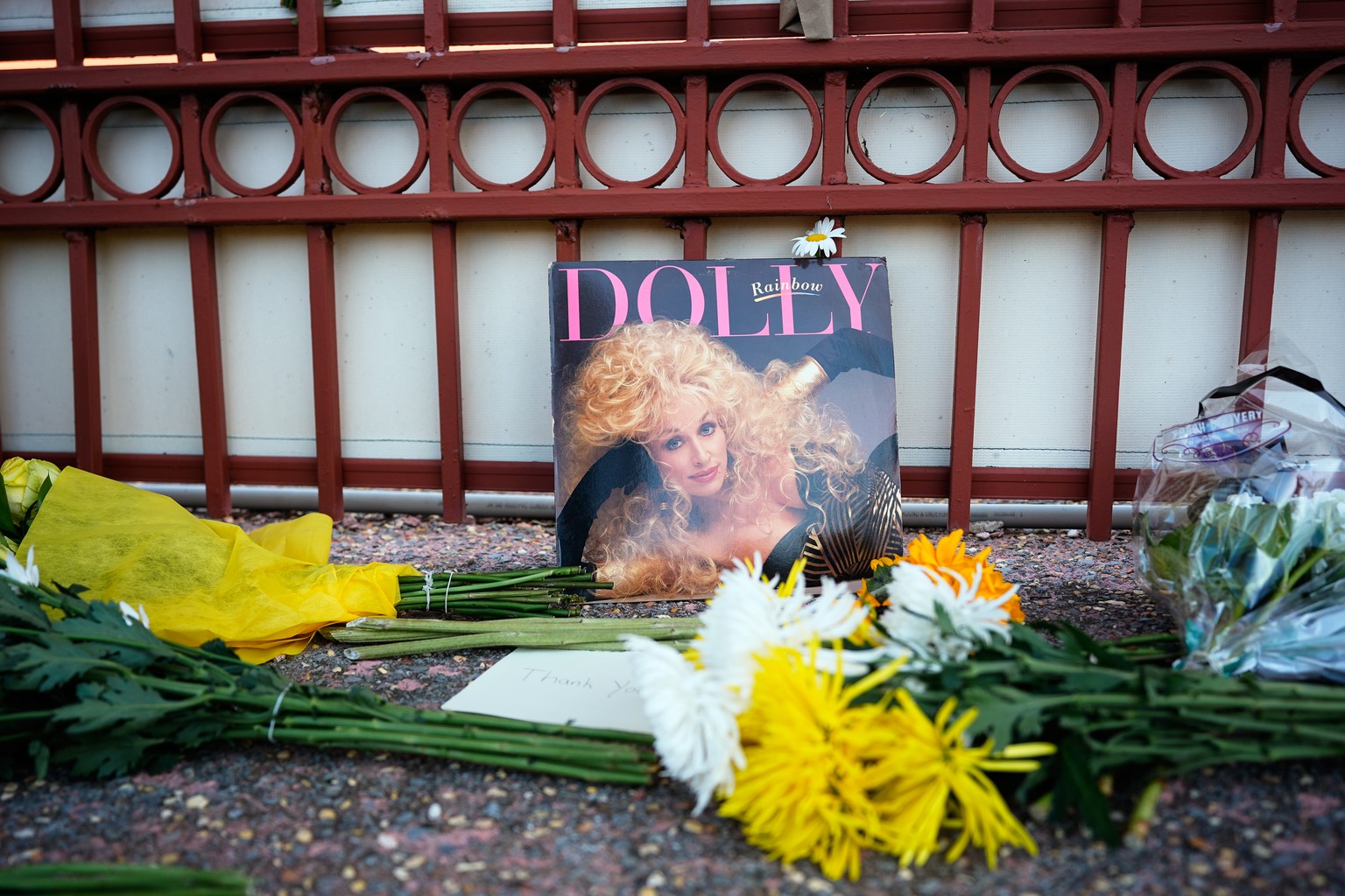 An album and flowers are left outside Dolly Parton's office on Tuesday, Aug. 25, 2026, in Nashville, Tenn. (AP Photo/George Walker IV)
Obit Dolly Parton