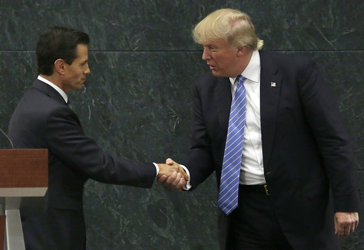FILE - In this Aug. 31, 2016 file photo, Mexico's President Enrique Pena Nieto, left, and Republican presidential nominee Donald Trump shake hands after a joint statement at Los Pinos, the presid ...