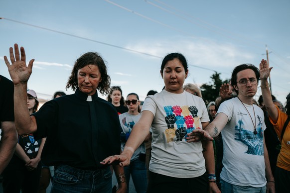 epa13149219 Protesters and members of the clergy pray at the Delaney Hall Immigration Detention Facility during a vigil and protest for Edwin Jovanny Lopez Cornejo, in Newark, New Jersey, USA, 03 Augu ...