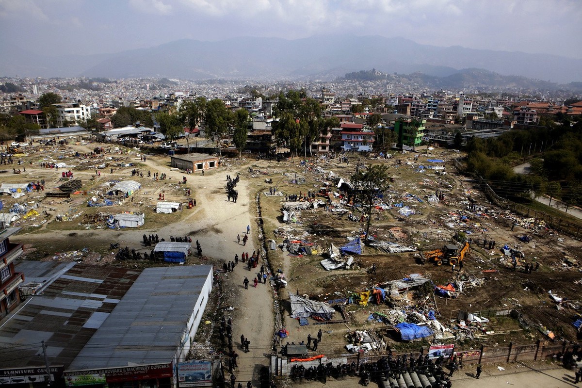 Police remove temporary houses in a quake victims' shelter in downtown Kathmandu, Nepal, Tuesday, March 14, 2017. Police tore down hundreds of temporary homes in the Nepalese capital where people ...