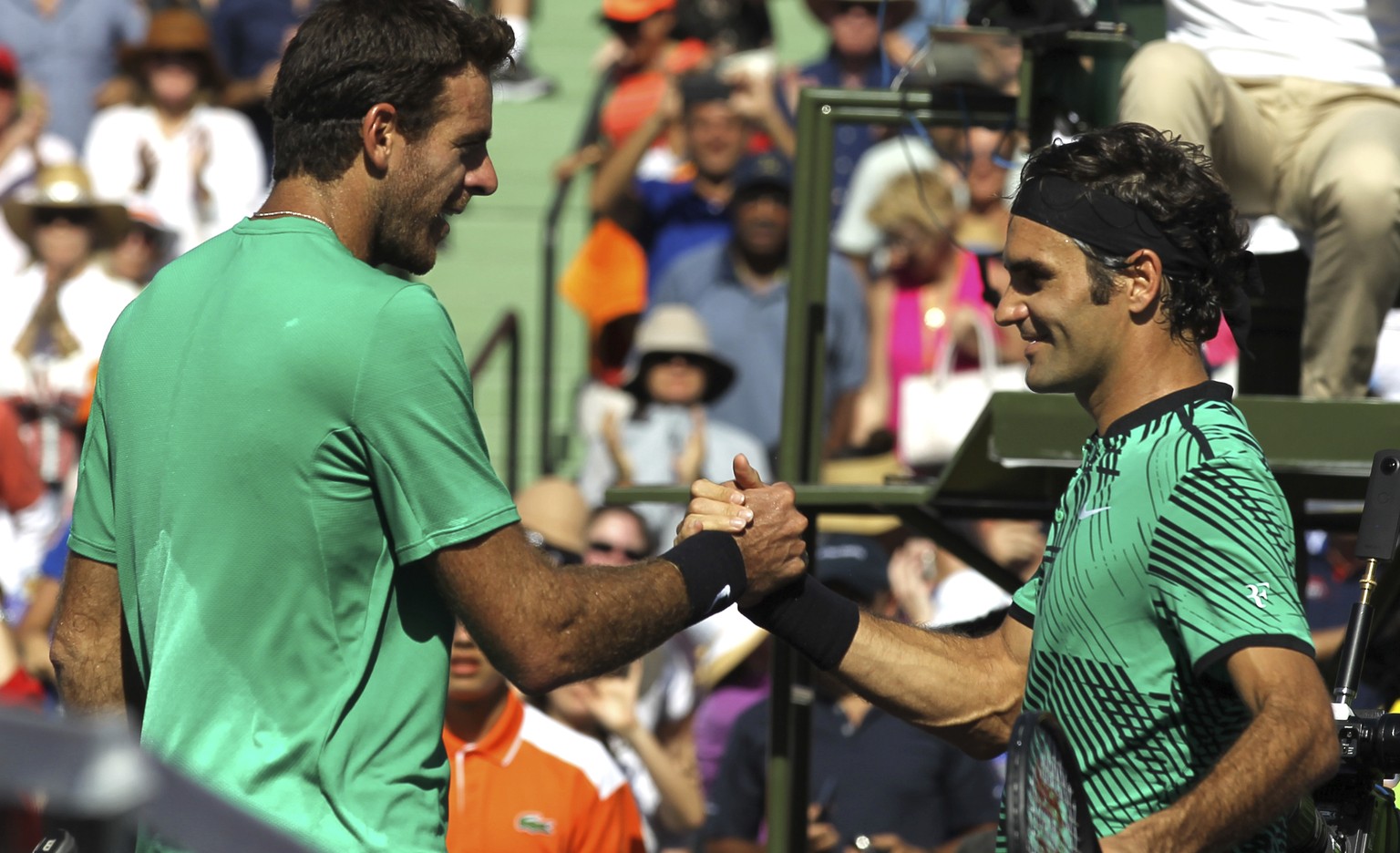 Roger Federer, right, of Switzerland, greets Juan Martin del Potro, left, of Argentina, at the net after defeating him 6-3, 6-4 during the Miami Open tennis tournament, Monday, March 27, 2017, in Key  ...